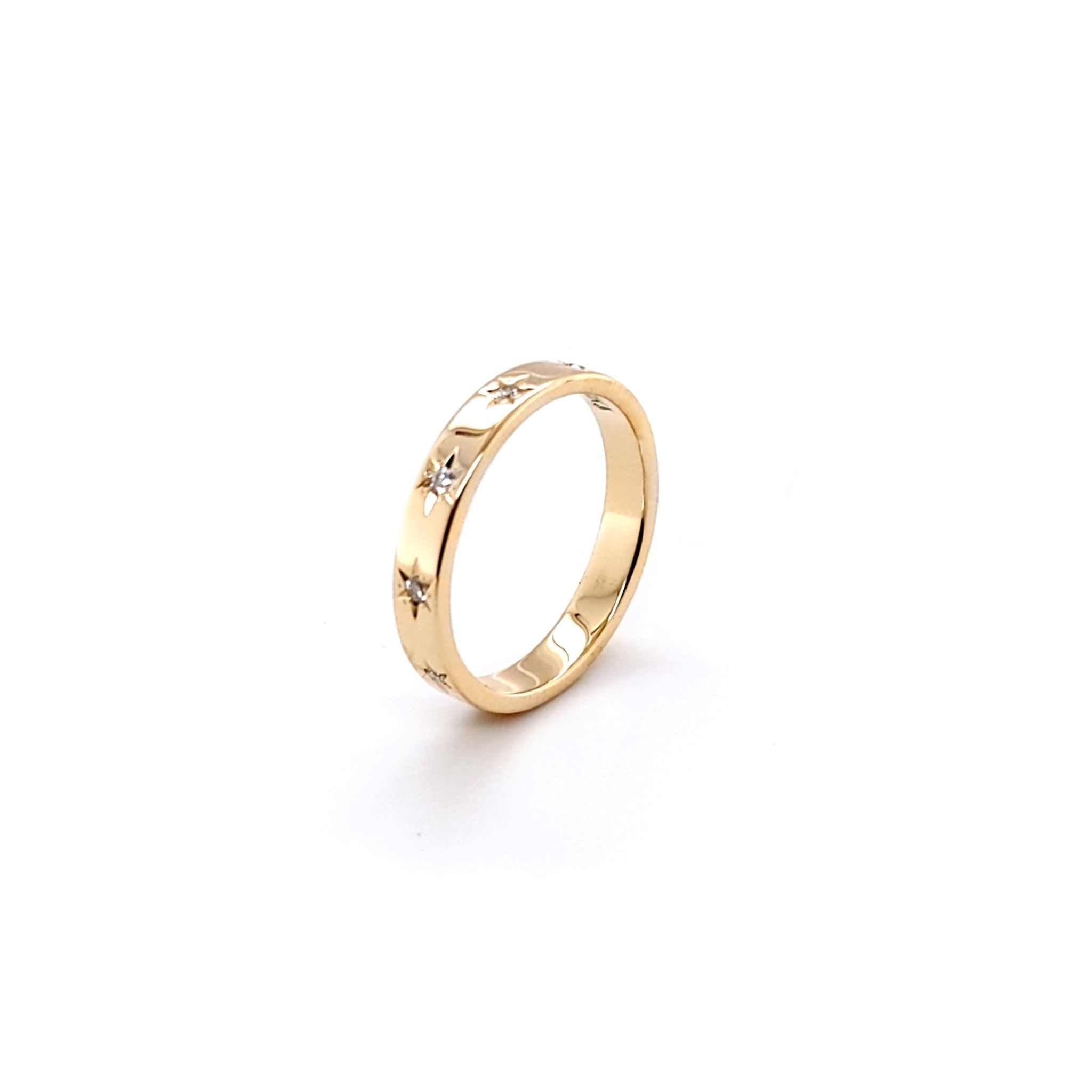 18K yellow gold Solace band with starburst design and blue sapphires.