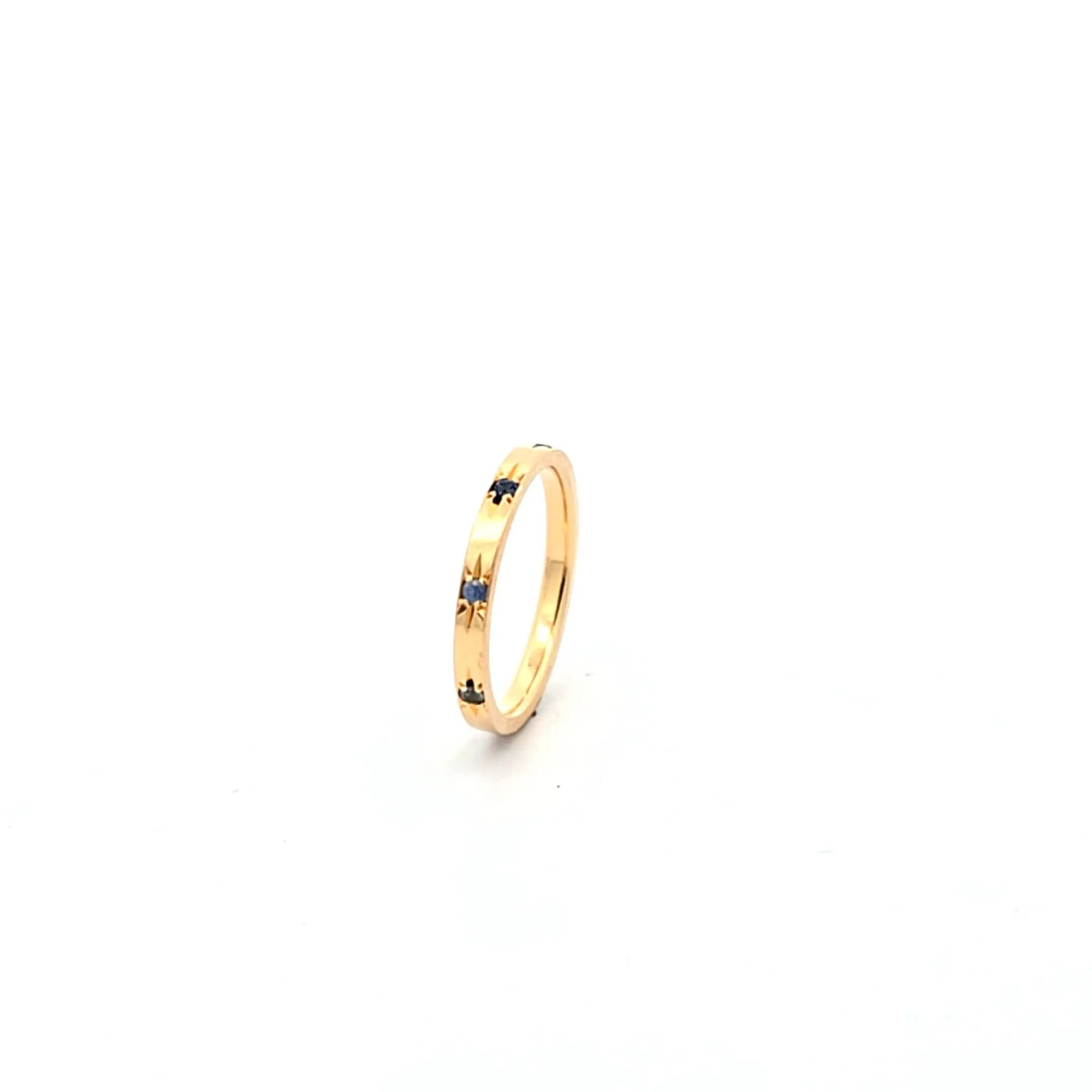 18K yellow gold Solace Band with starburst design and blue sapphires, inspired by the night sky