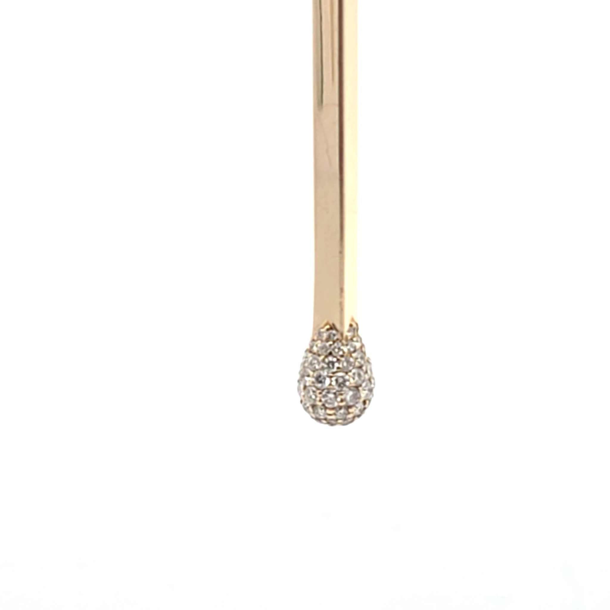 Close-up of 14k yellow gold Matchstick Necklace pendant with pave set diamonds on white background