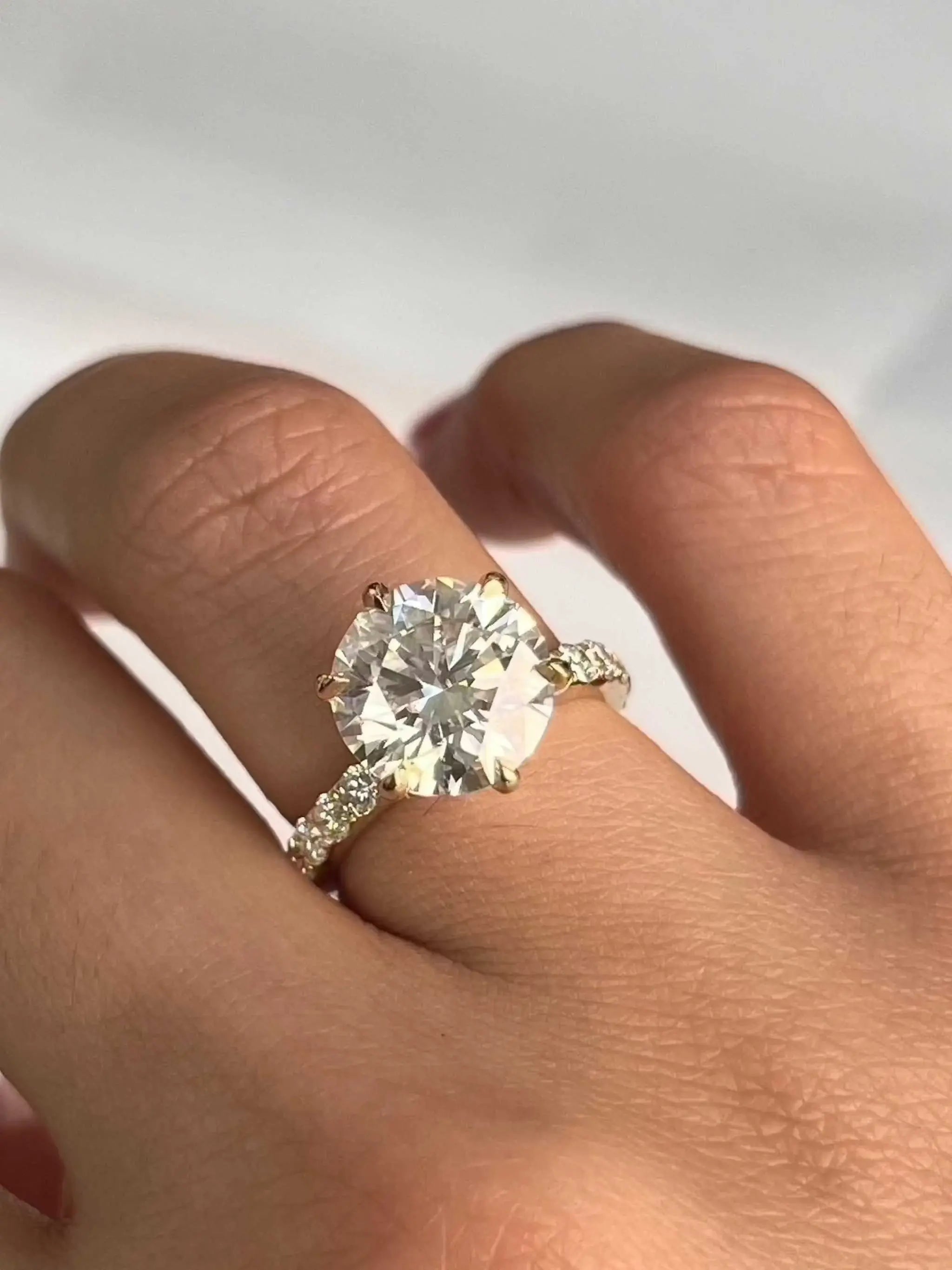 Classic Engagement Ring featuring 4.4ct brilliant-cut diamond in 18K yellow gold with diamond-adorned band