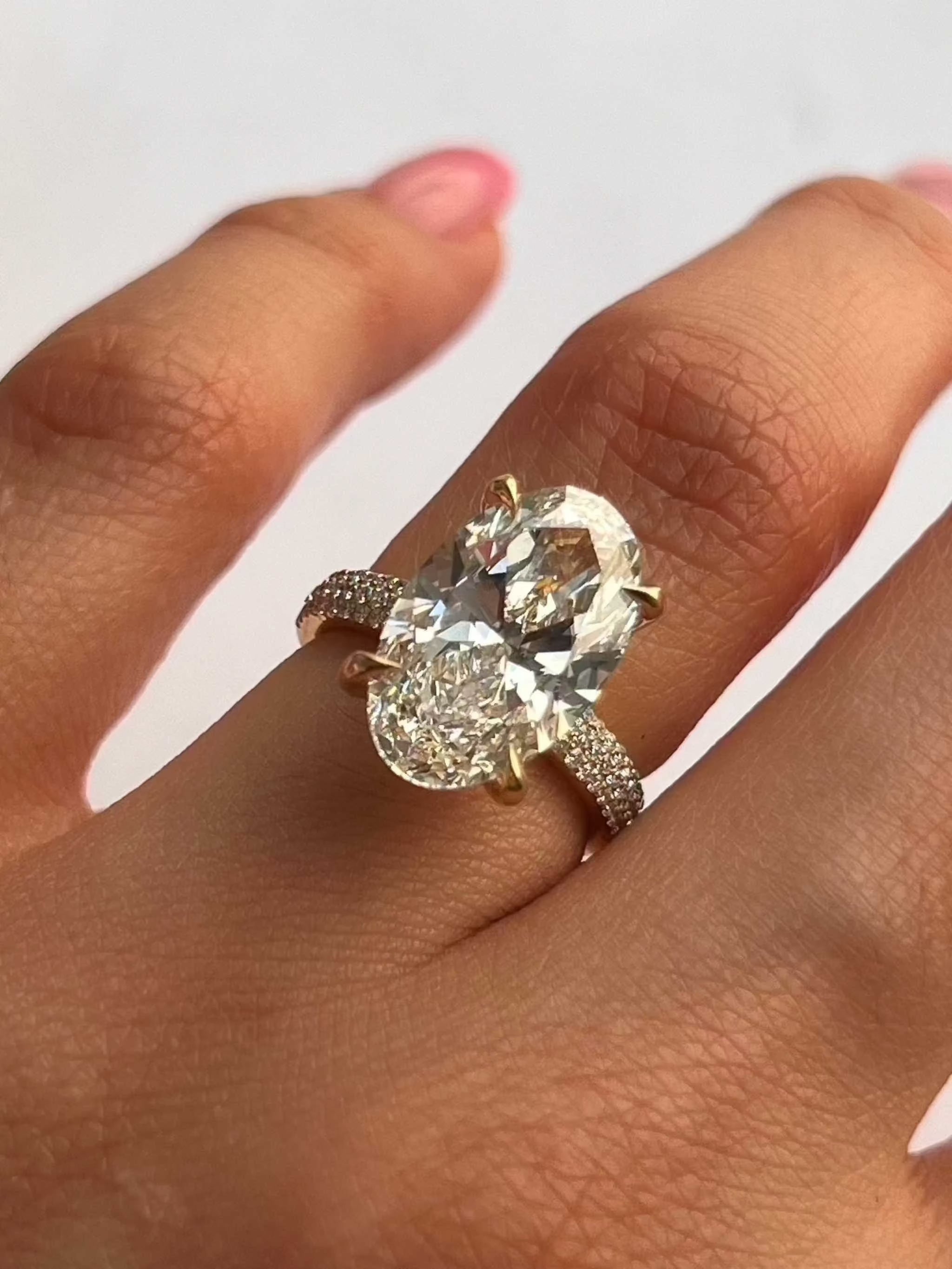 Chelsea Engagement Ring with 6ct oval diamond and pavé diamond band on finger