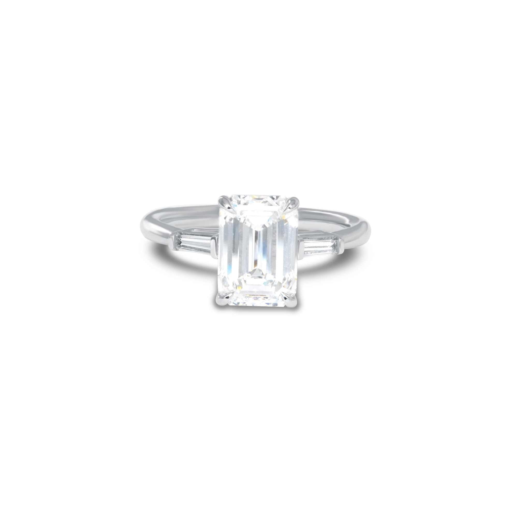 Meira three stone engagement ring with 2-carat emerald-cut diamond and FG VS baguette diamonds on silver band