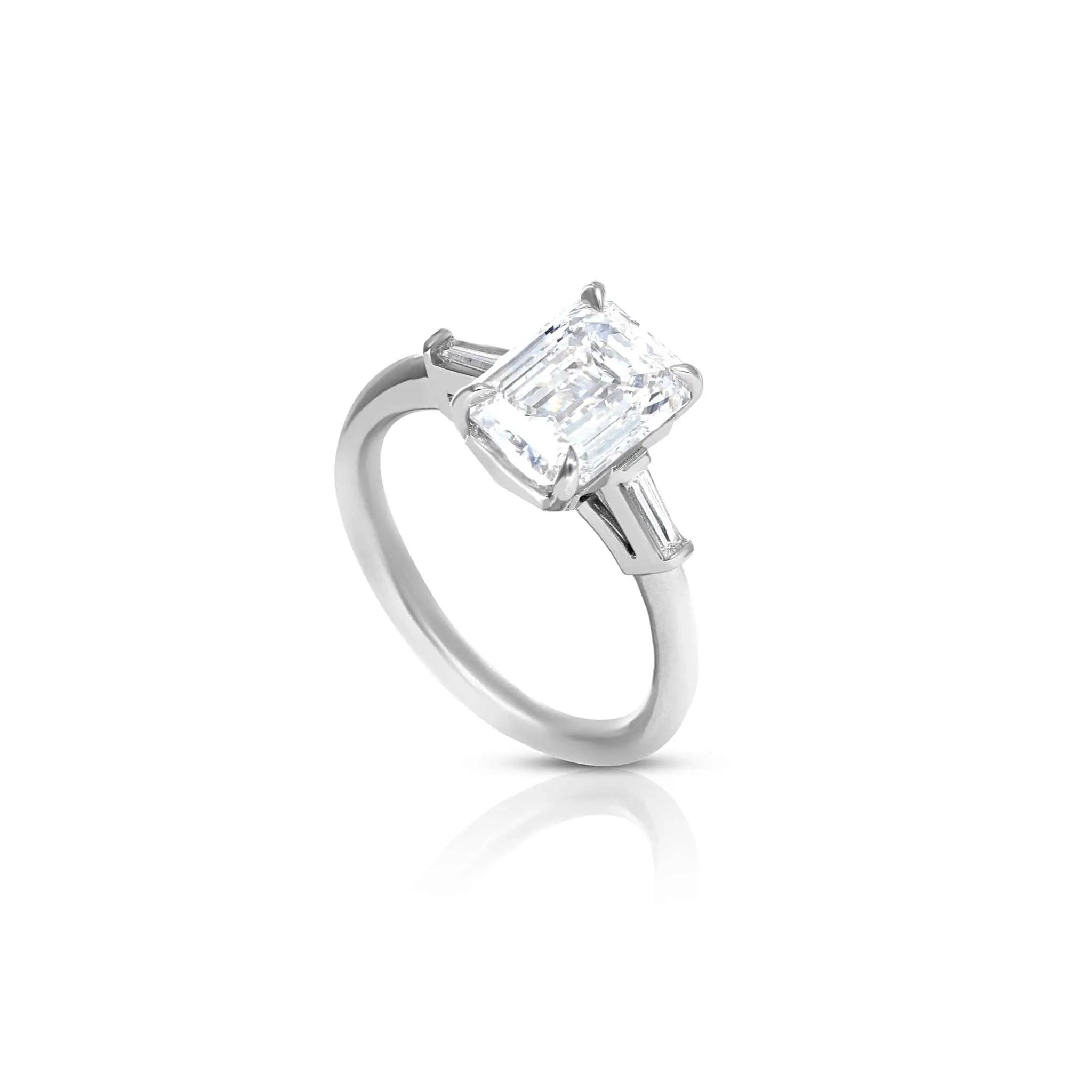 Meira three stone engagement ring with baguette diamonds and emerald-cut center stone