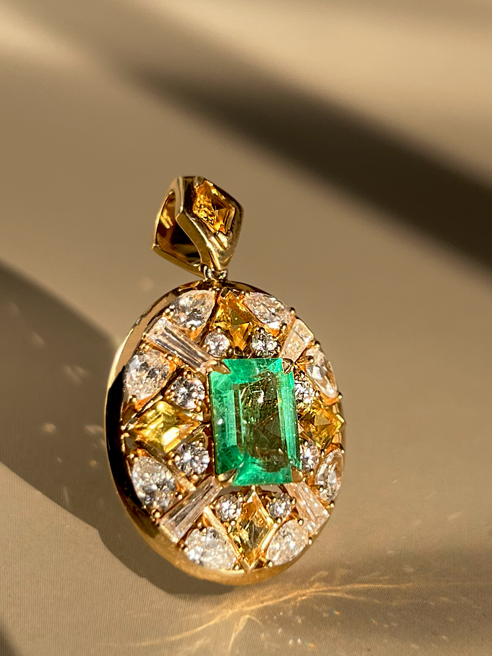 Zia Necklace pendant with 1.59-carat emerald, yellow sapphires, and VS diamonds set in 18K yellow gold