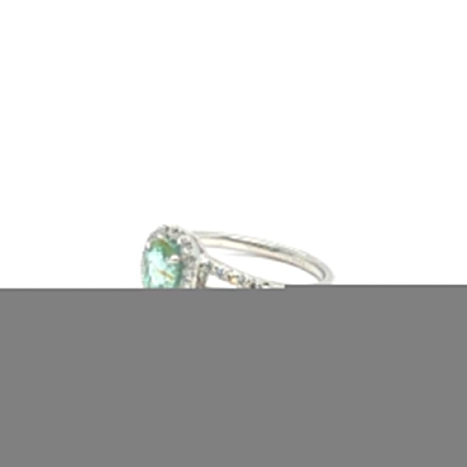 Gigi Alternative Engagement Ring with teal Paraiba Tourmaline center stone and diamond accents on silver band