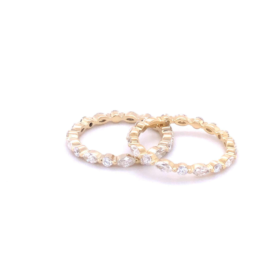 Bella wedding band in 18K yellow gold with 0.85 carats FG VS1 round and marquise diamonds, elegant and timeless design.