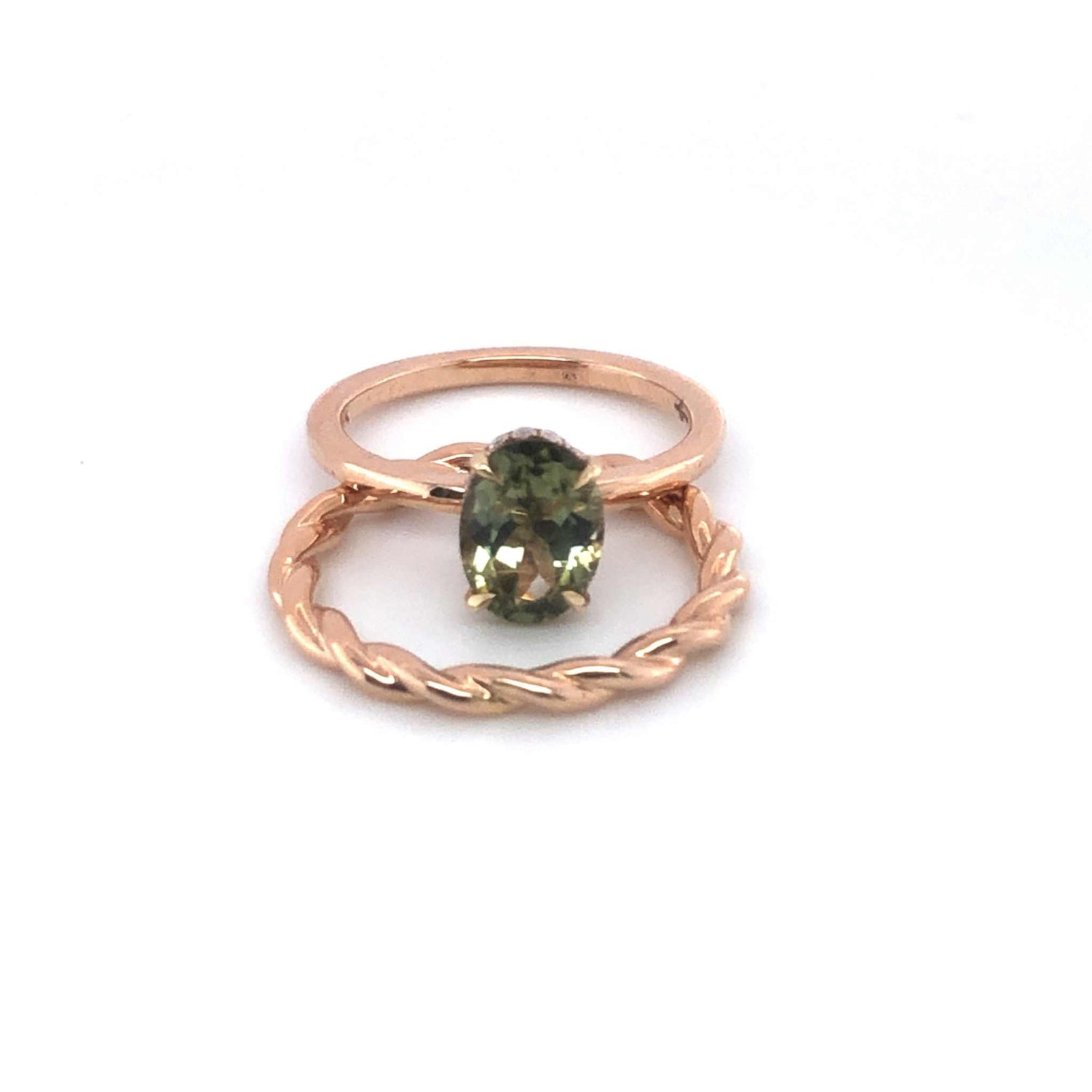 Gloria Alternative Engagement Ring with green oval center stone and twisted rose gold band with hidden halo design