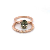 Gloria Alternative Engagement Ring with green oval center stone and twisted rose gold band with hidden halo design