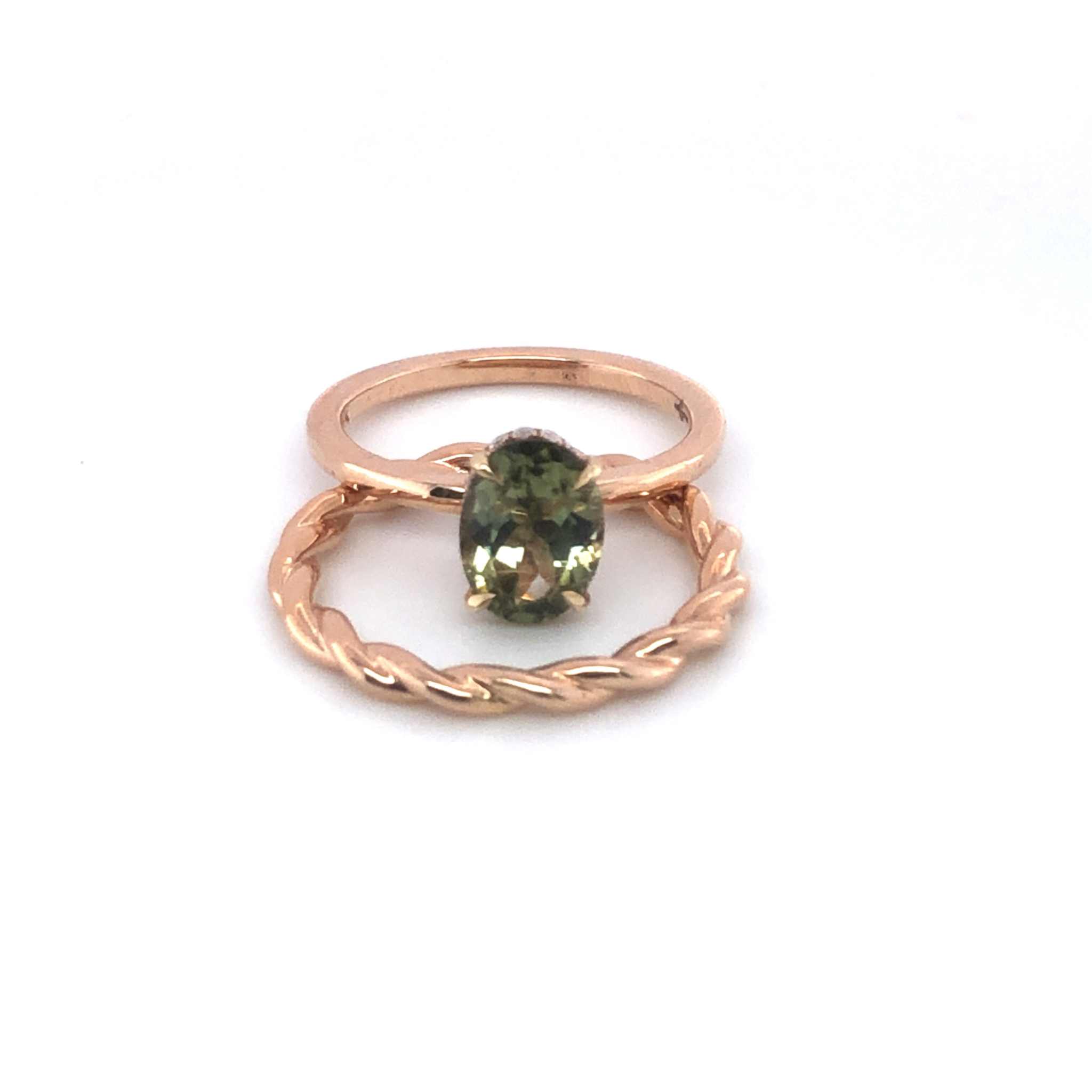 Gloria Alternative Engagement Ring with green oval center stone and twisted rose gold band with hidden halo design