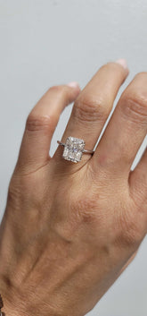 Mimi Hidden Halo Engagement Ring with radiant cut diamond and hidden halo setting on finger