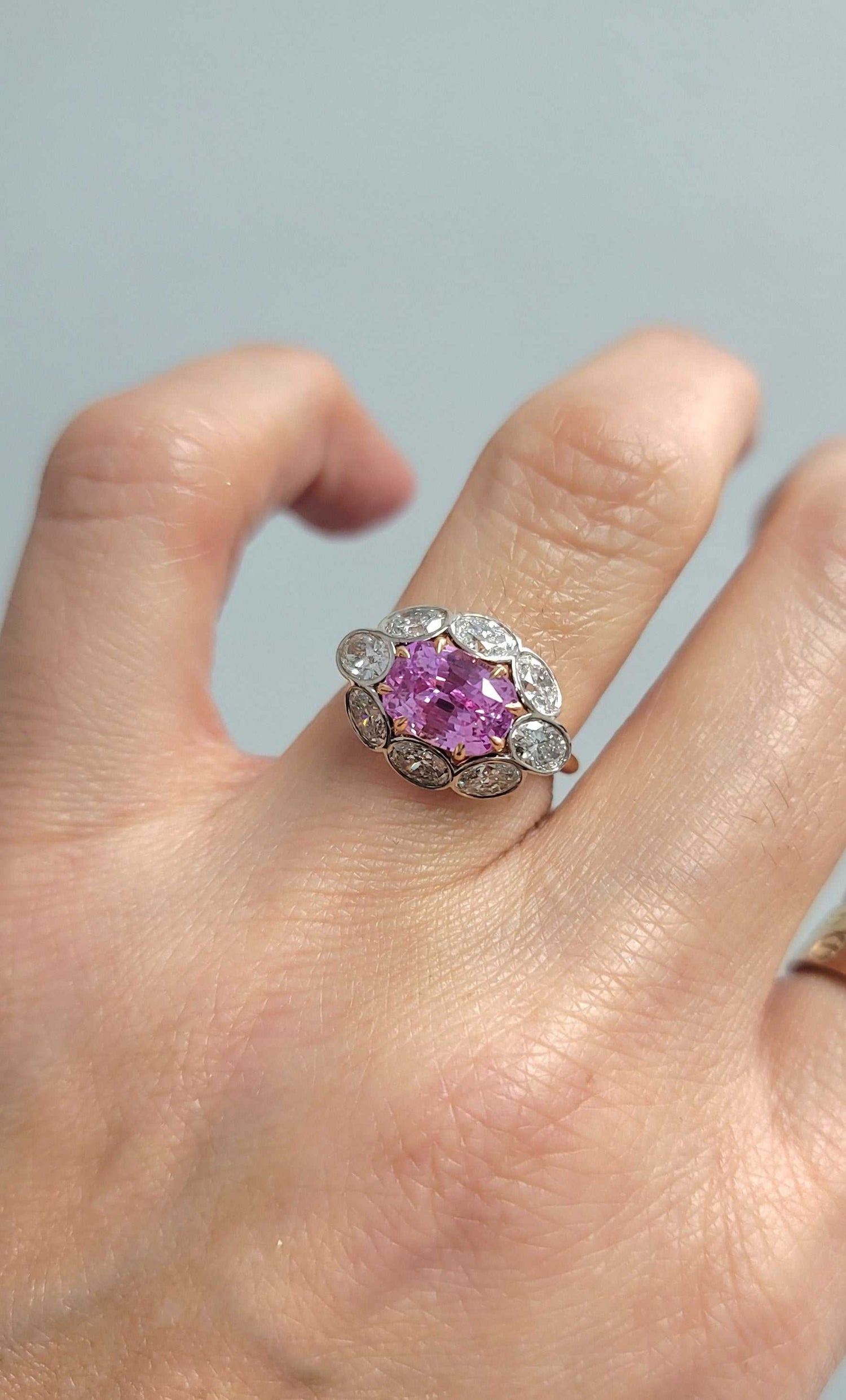 Sami Pink Sapphire and Diamond ring featuring a 3.18-carat cushion-cut pink sapphire surrounded by 1.6 carats of diamonds in 18K rose and white gold