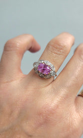Sami Pink Sapphire and Diamond ring featuring a 3.18-carat cushion-cut pink sapphire surrounded by 1.6 carats of diamonds in 18K rose and white gold