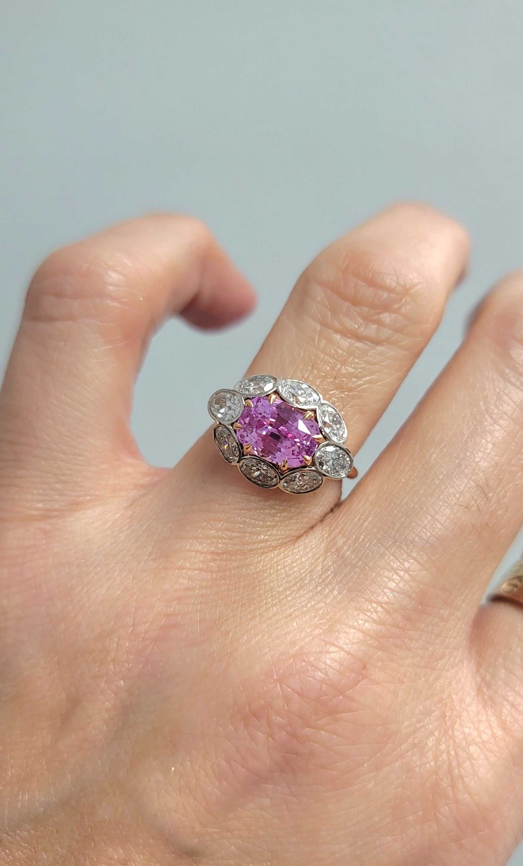Sami Pink Sapphire and Diamond ring featuring a 3.18-carat cushion-cut pink sapphire surrounded by 1.6 carats of diamonds in 18K rose and white gold