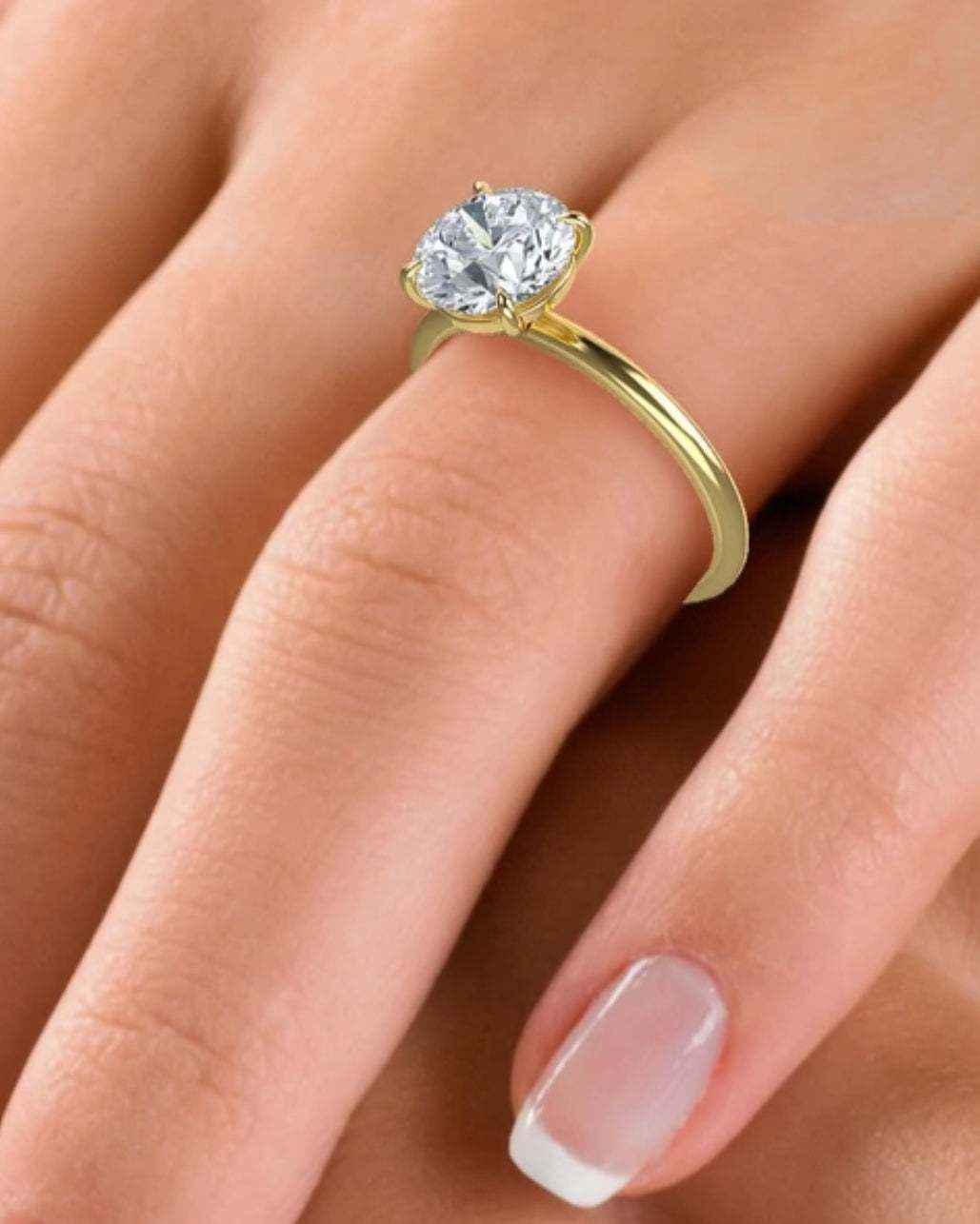 Cleo Solitaire Engagement Ring with 2ct brilliant diamond set in 18K gold on finger