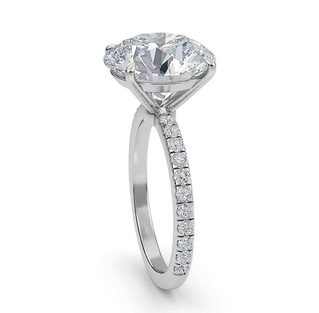 Ora engagement ring in platinum with a large VS center diamond and smaller F VS1 diamonds on the band.