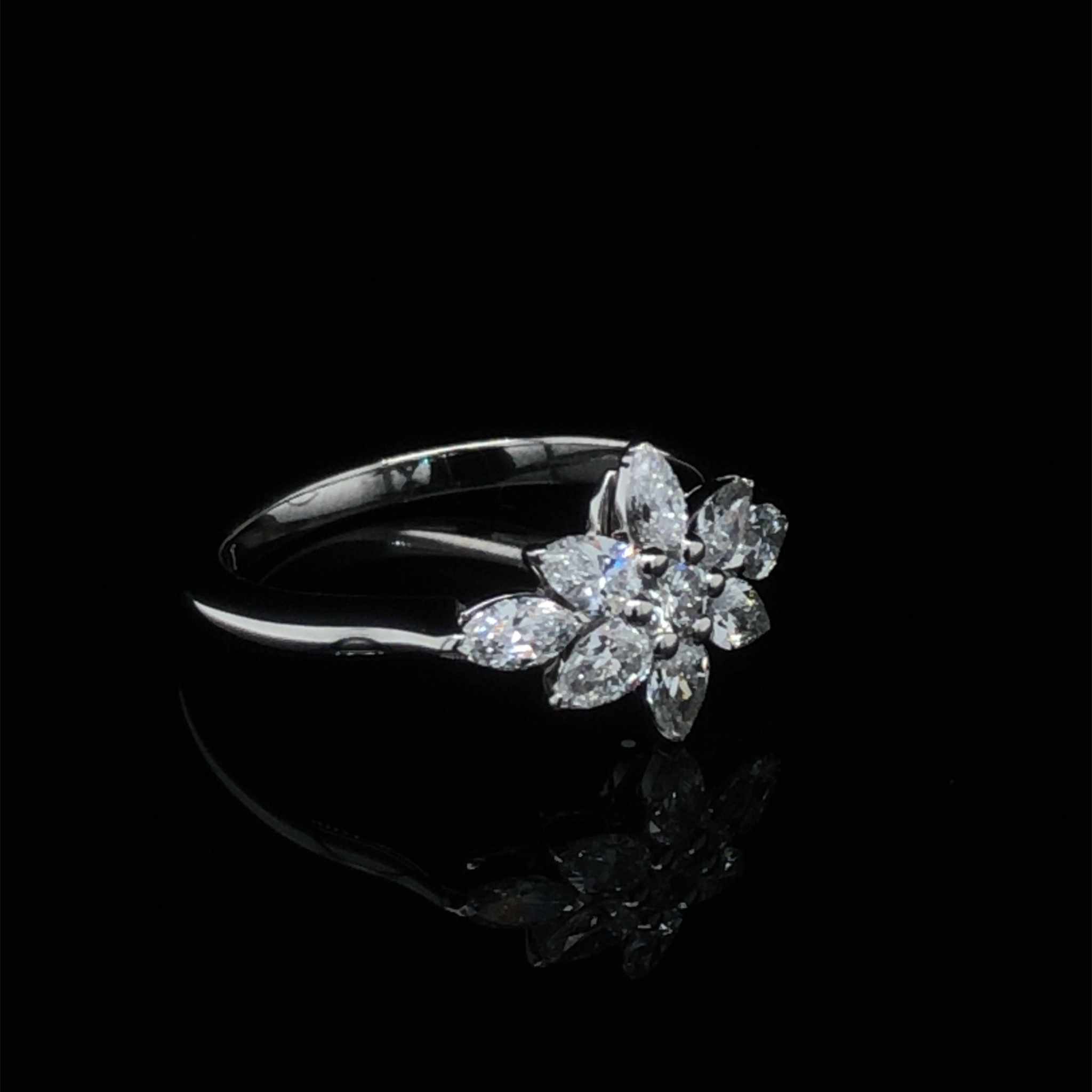 Daisy Engagement Ring with pear, marquise, and round diamonds in platinum knife-edge setting