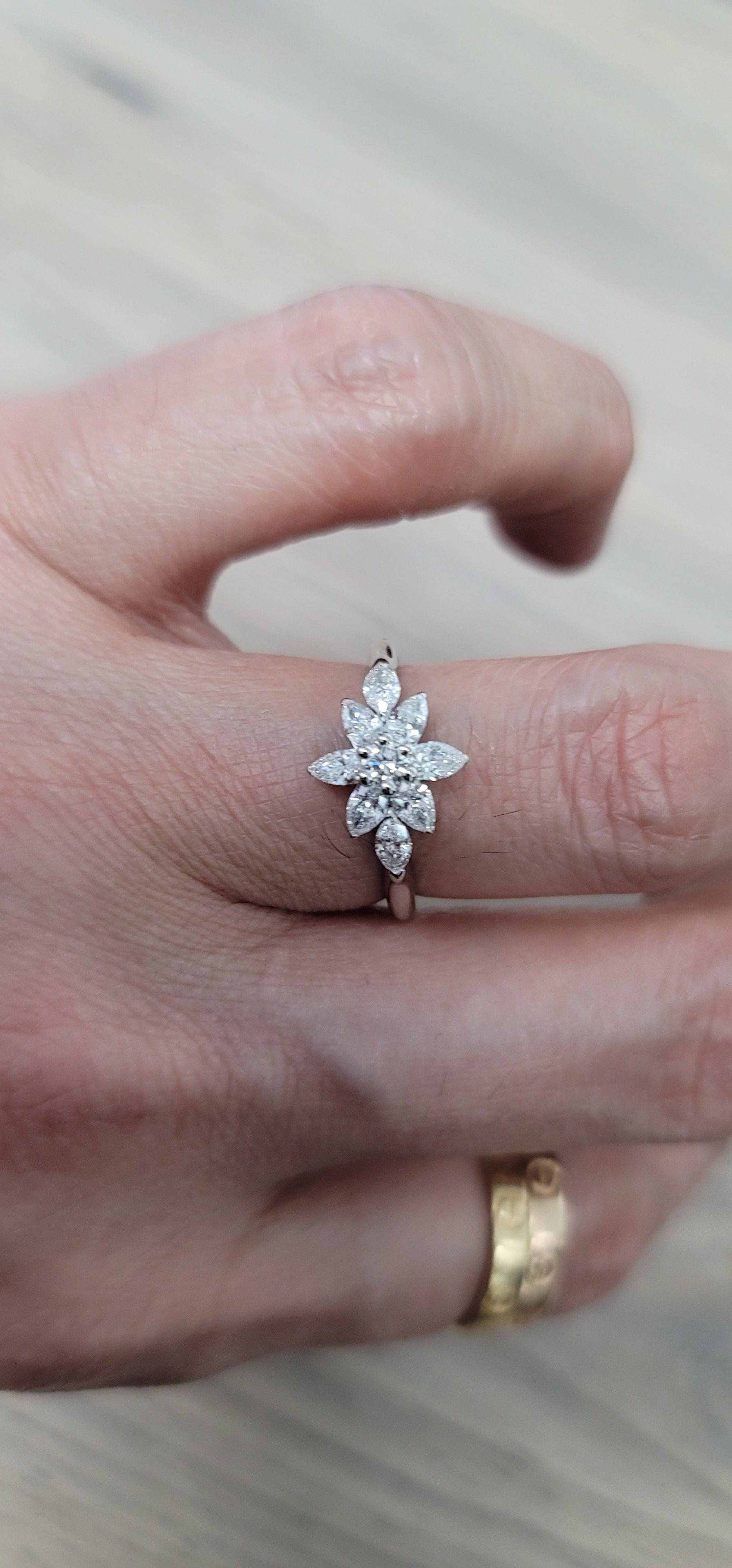 Daisy Engagement Ring with pear, marquise, and round diamonds in platinum setting on hand