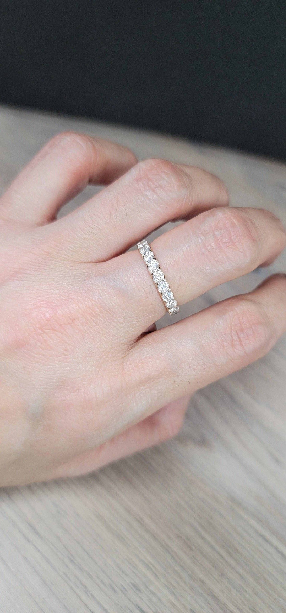 Mona Diamond Wedding Band in 18K yellow gold with sparkling diamonds on finger