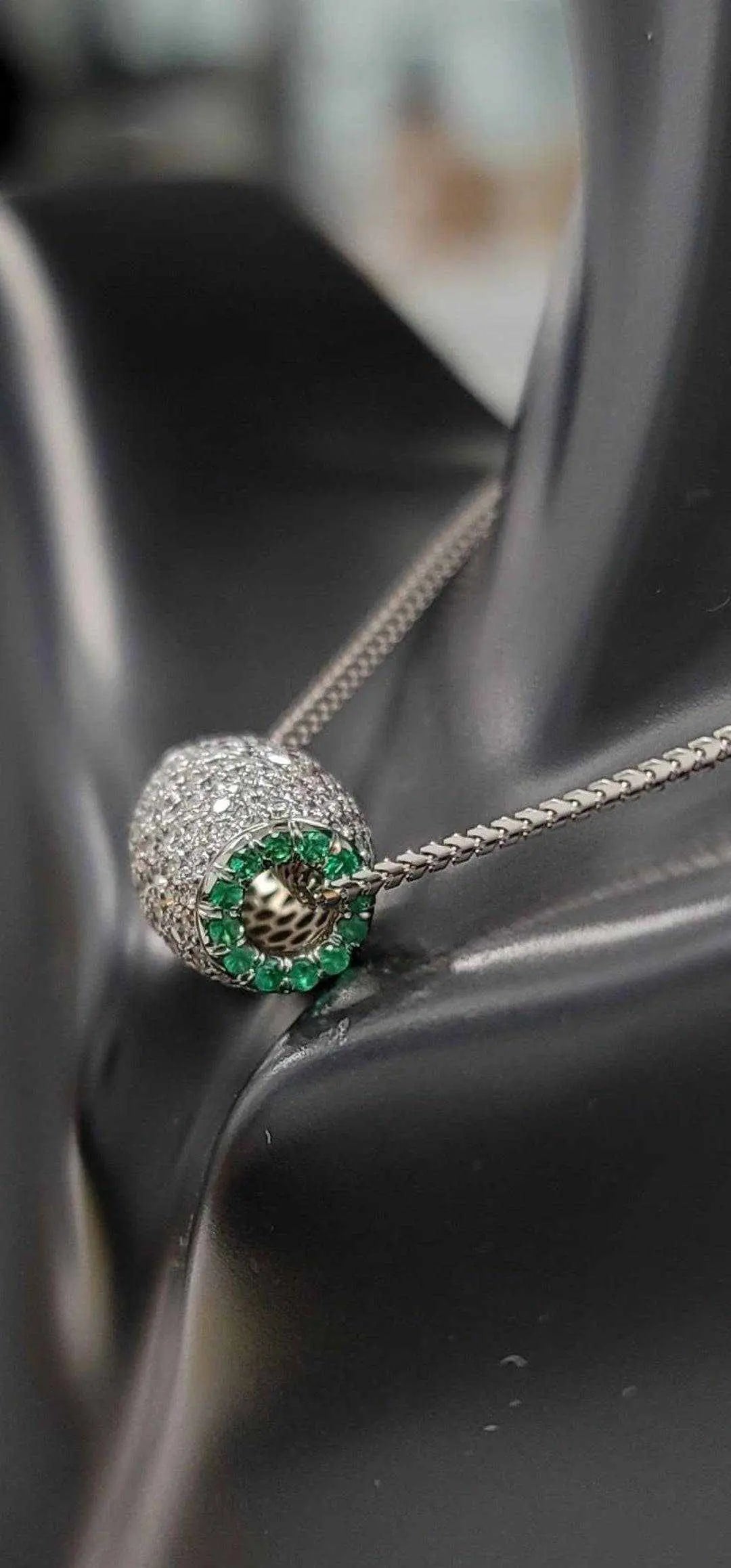 Ariella Necklace in 18K white gold with 2.2 carats of VS diamonds and green emerald accents on a silver chain