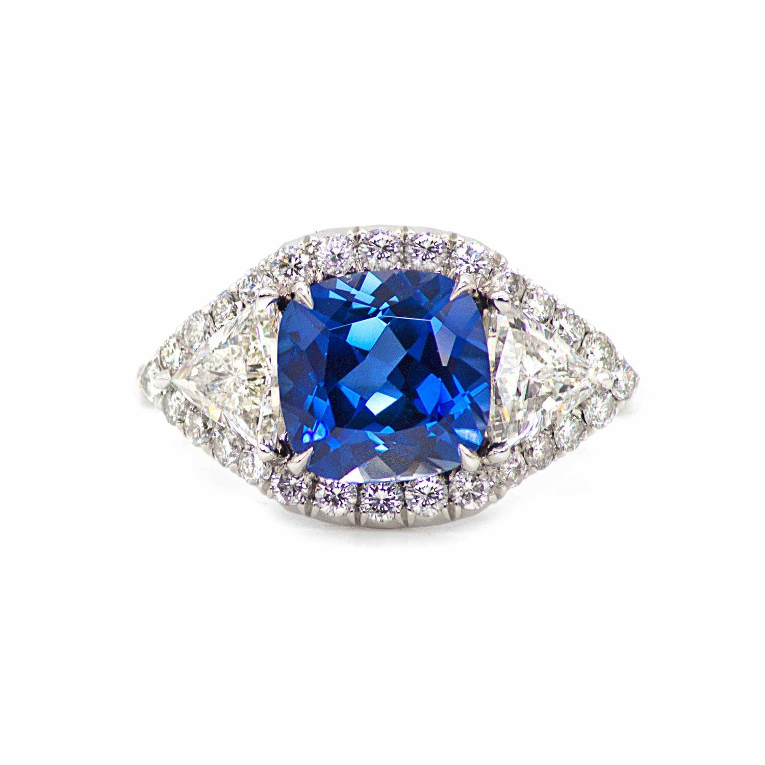 Hailey 3 Stone Halo Sapphire ring with cushion-cut blue sapphire and round diamonds in platinum setting