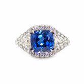 Hailey 3 Stone Halo Sapphire ring with cushion-cut blue sapphire and round diamonds in platinum setting
