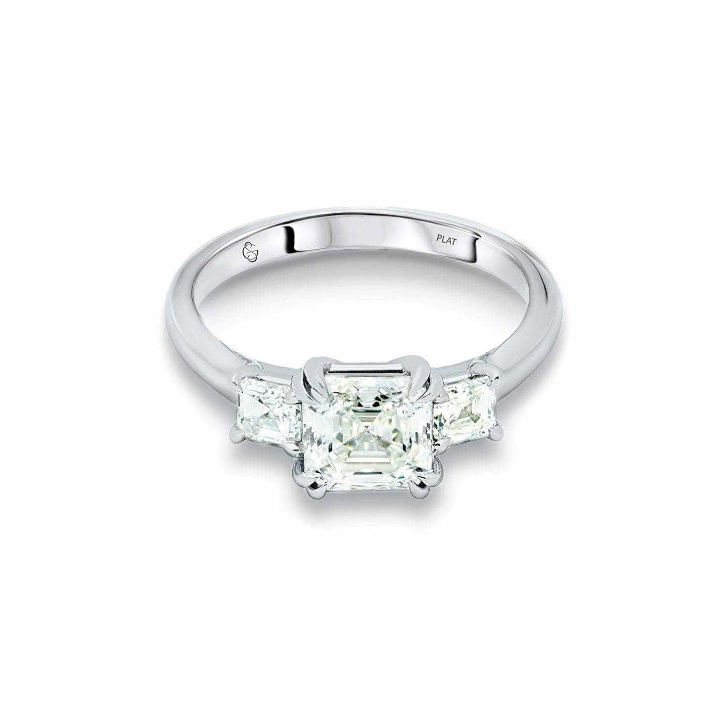 Leeba Three Stone Engagement Ring with 2ct Asscher-cut center diamond and 0.5ct Asscher-cut side stones in a sleek platinum band