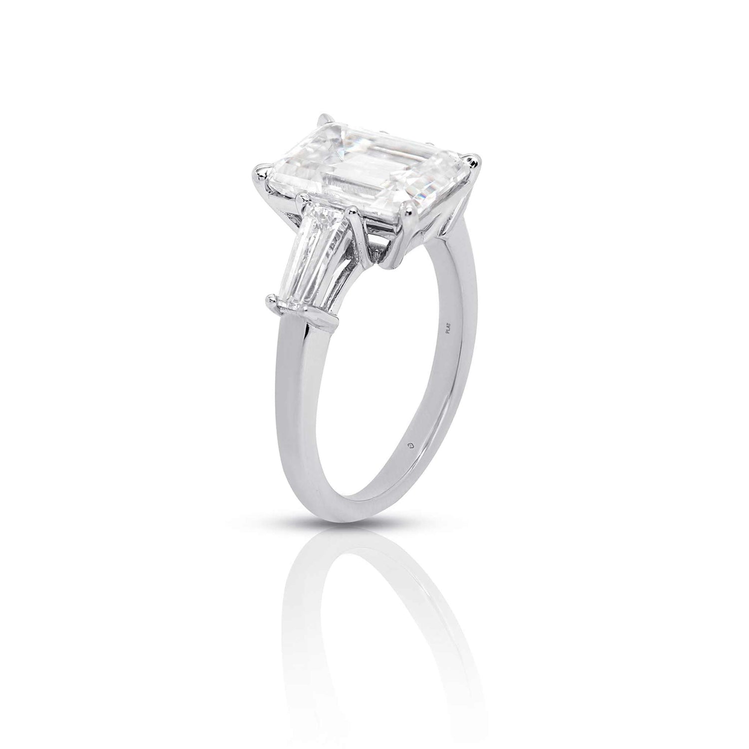 Meira three stone engagement ring with 2-carat emerald-cut diamond and 1.01 carats FG VS baguette diamonds in a silver band