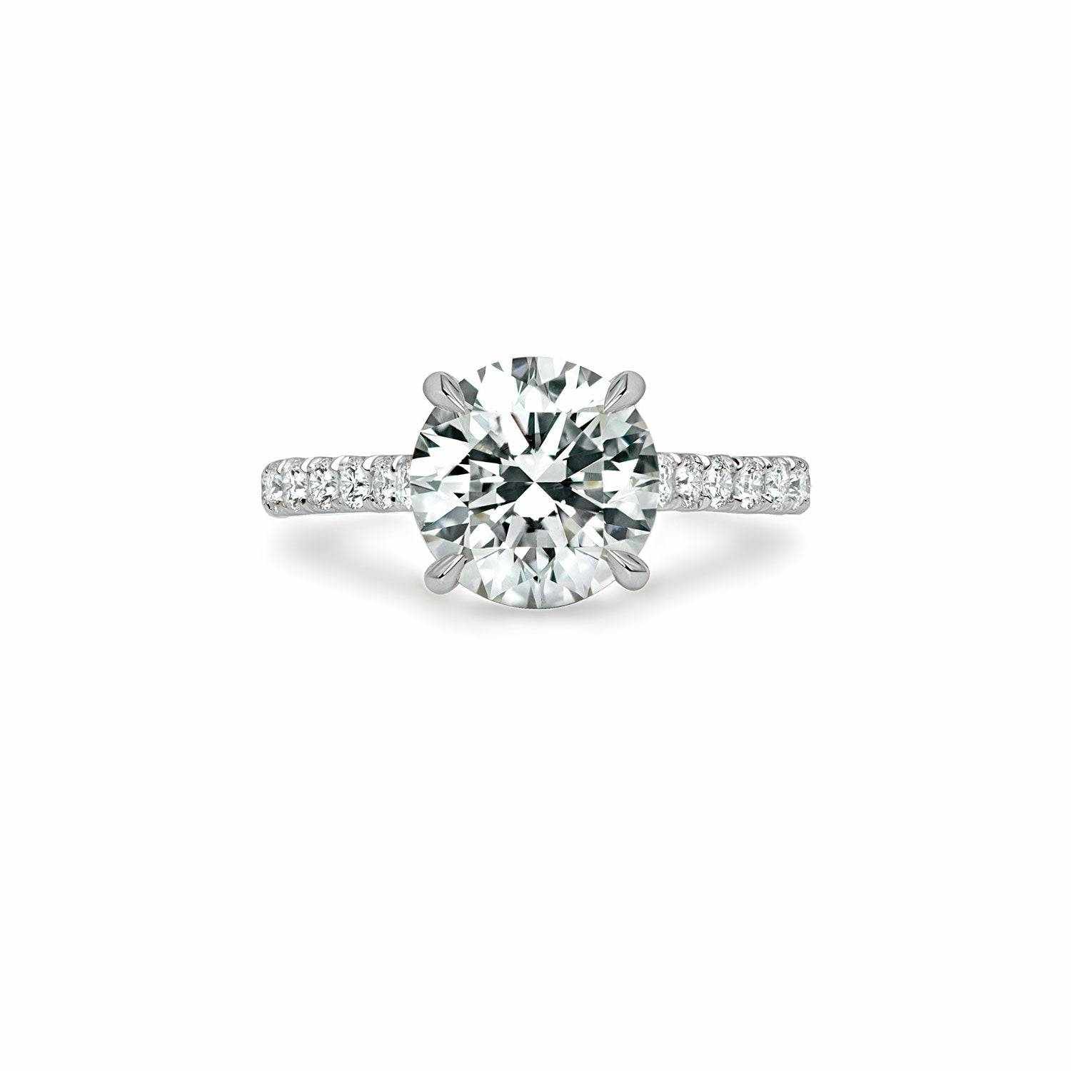 Ora Engagement Ring with a large VS center diamond and smaller surrounding F VS1 diamonds on a platinum or 18K gold band