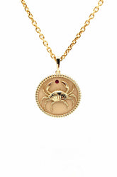18K gold Zodiac Medallion necklace with crab design and red birthstone on cable chain