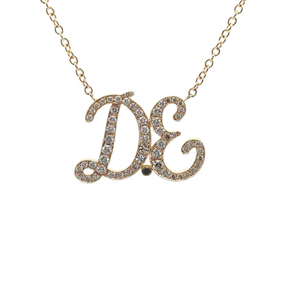 Diamond initial necklace in 18-karat gold with pavé diamonds on adjustable chain.