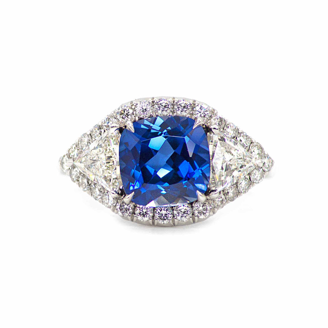 Hailey 3 Stone Halo Sapphire ring with cushion-cut blue sapphire and round diamonds in platinum setting