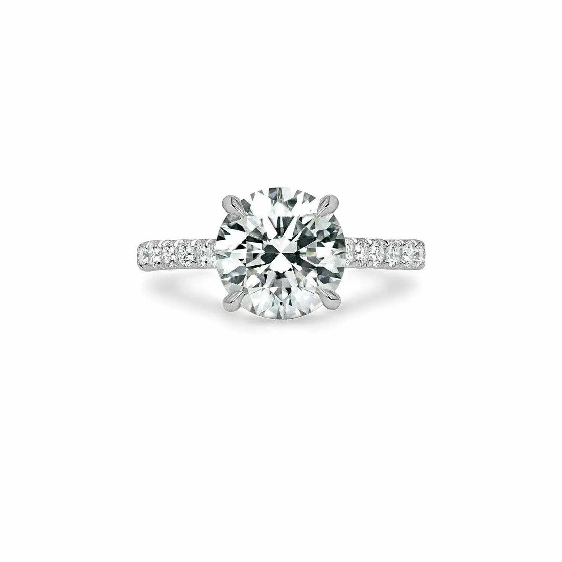 Ora Engagement Ring with a large VS center diamond and smaller surrounding F VS1 diamonds on a platinum or 18K gold band